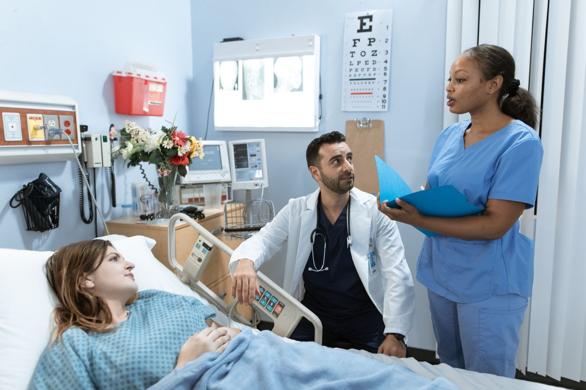 Doctors and nurse discussing patient treatment